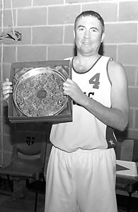 Coach McCusker with the Ernie Oliver Memorial Trophy. (Converted to B&W due to colour issues.)